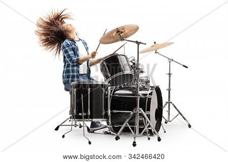 Female drummer playing on a drum set and throwing hair back isolated on white background