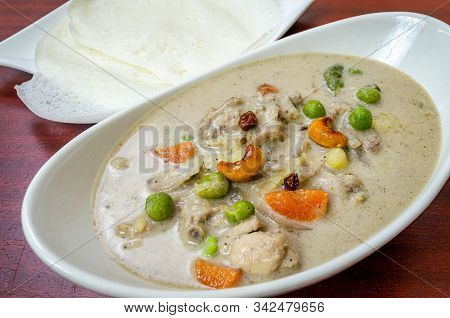 Traditional Chicken Stew In Kerala Style With Cashew And Vegetables Along With Appams.