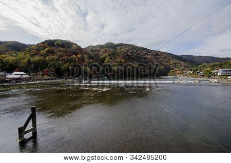 Katsuragawa River With Colourful Forest Mountain Background In Arashiyama District, Kyoto