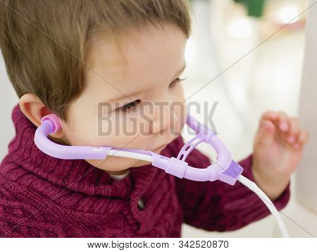 Childrens And Phonendoscope. Little Kid Boy With Phonendoscope Playing Doctor. Healthcare And Medici
