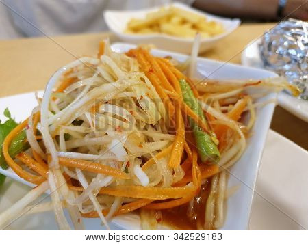 Thai Food Style, Selective Focus Of Papaya Salad With Tomato, Shrimp, Chili And Bean On White Plate 