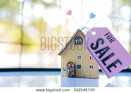 Home For Sale And Real Estate Mortgage Concept: Diy Little House Model With Tag Paper 