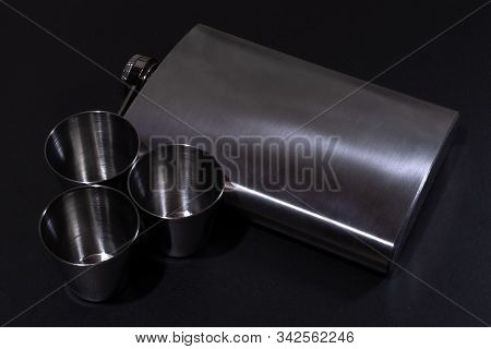 Metall Hip Flask On Black Backdrop. Flasks For Alcohol.
