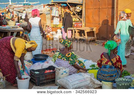 Tanji, The Gambia - November 21, 2019: Scene With Men And Women Carrying Fish From The Boats To The