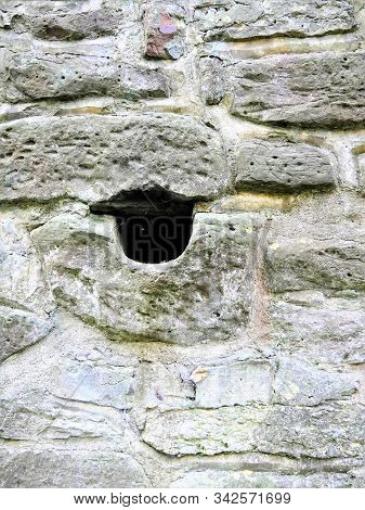 A Big City Wall With A Hole
