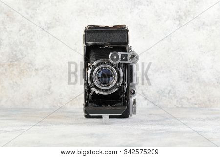 Old Soviet Medium Format Rangefinder Camera Moskva-4, Released 1956 On Gray Cement Background. Camer