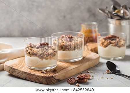Parfait. Granola Parfait. Delicious Natural Yogurt Parfait With Caramel, Pecan Nuts On Conctere Back