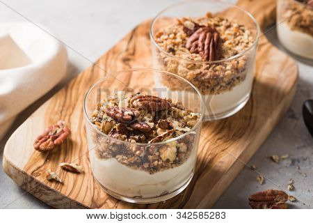 Parfait. Granola Parfait. Delicious Natural Yogurt Parfait With Caramel, Pecan Nuts On Conctere Back