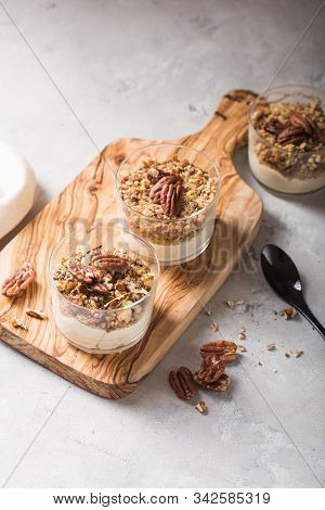 Parfait. Granola Parfait. Delicious Natural Yogurt Parfait With Caramel, Pecan Nuts On Conctere Back