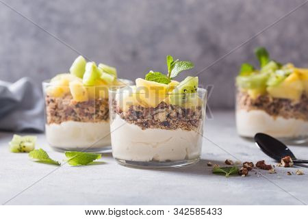 Parfait. Granola Parfait. Homemade Yogurt Parfait With Granola, Kiwi Fruit, Pineapple And Nuts In A 