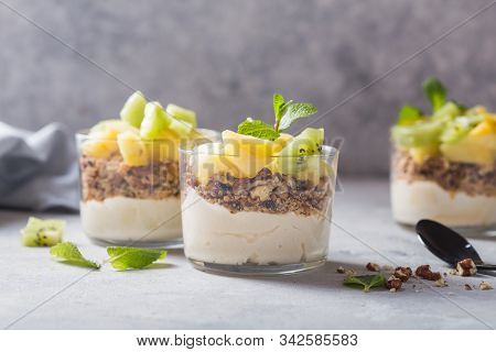 Parfait. Granola Parfait. Homemade Yogurt Parfait With Granola, Kiwi Fruit, Pineapple And Nuts In A 