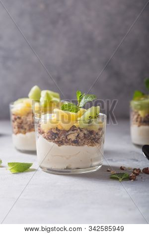 Parfait. Granola Parfait. Homemade Yogurt Parfait With Granola, Kiwi Fruit, Pineapple And Nuts In A 
