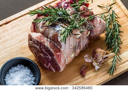 Raw Rolled And Tied Herdwick Sheep Lamb Joint Prepared With Garlic, Rosemary And Sea Salt.