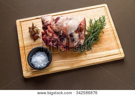 Raw Rolled And Tied Herdwick Sheep Lamb Joint With Garlic, Rosemary And Sea Salt.