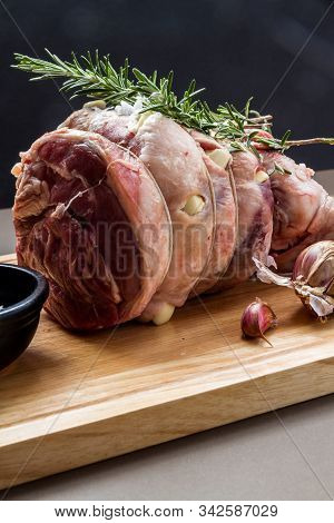 Raw Rolled And Tied Herdwick Sheep Lamb Joint Prepared With Garlic, Rosemary And Sea Salt.