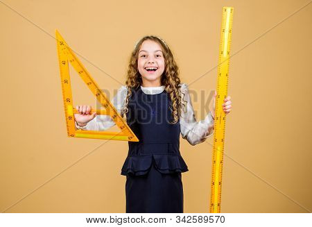 Sizing And Measuring. School Student Study Geometry. Kid School Uniform Hold Ruler. Pupil Cute Girl 