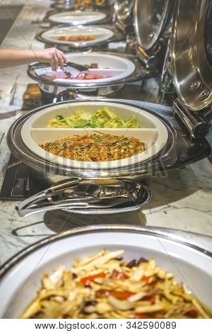 Fried Noodles And Boiled Pakchoy In A Serving Bowl As A Asian Style Breakfast Buffet On The Table In