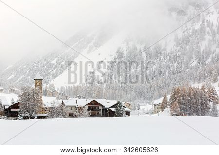 Alpine Village Tschierv During Snowfall. Val Muestair Municipality In The District Of Inn In The Swi