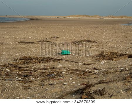 Plastic Debris Bottlecaps Styrofoam Garbage On Beach On A Sunny Winter Day At Sandy Hook, Nj