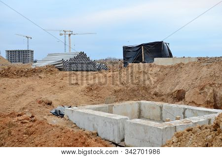 Installation Of Concrete Sewer Wells In The Ground At The Construction Site. The Use Of Reinforced C