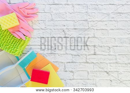 Detergents, Cleaning Accessories, Rubber Gloves, Rags And Sponges For Dishwashing On A White Brick B