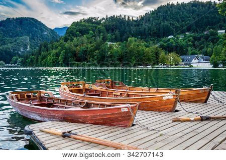Three Wooden Boats Parked In A Dock In The Bled Lake