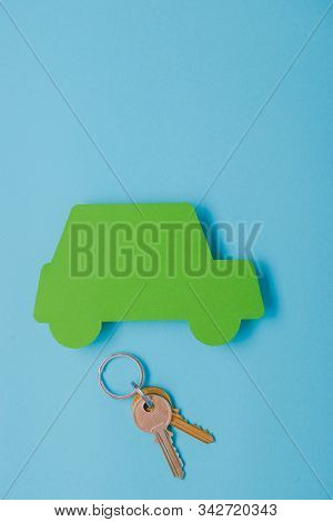 Paper Green Cars Figure With Keys. Top View On Blue Background