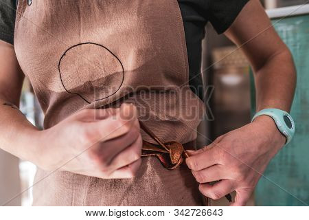 Chef Tying Leather Rope Of Brown Apron