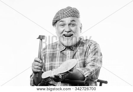 Retro Man Repair Shoes With Hammer. Mature Shoemaker In Workshop Make Shoes. Shoemaker Working With 