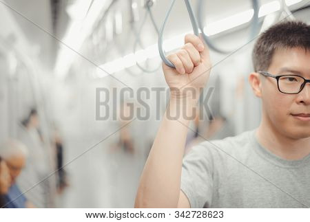 City Living Concept Male Hand Holding A Looped Handle In Urban Public Transportation