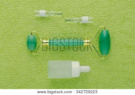 Jade Facial Roller And Face Serum In Ampoules And Bottle
