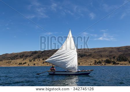 Titicaca Lake, Peru - October 14, 2015: A Man Steering A Sailboat On The Tititaca Lake On The Peruvi
