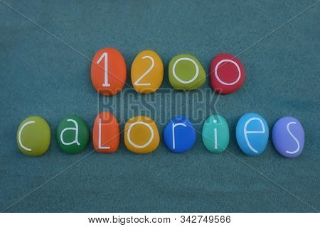 1200 Calories Diet Text Composed With Multi Colored Stone Letters And Numbers Over Green Sand