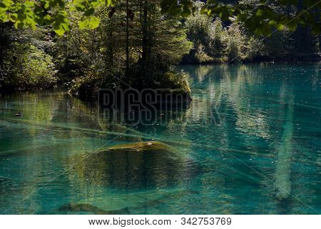 Deep Blue Mountain Lake Blausee In Bernese Oberland, Switzerland
