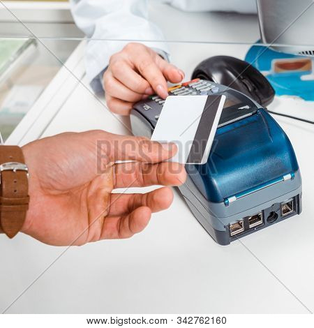 Cropped View Of Man Paying With Paypass In Pharmacy