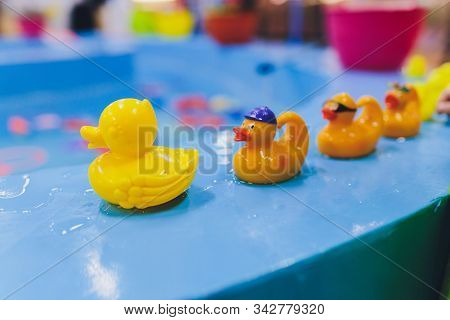Fishing In The Paddling Pool. Childrens Toys In The Pool. Toy Fish Fishing Rod. Cheerful Children Fi