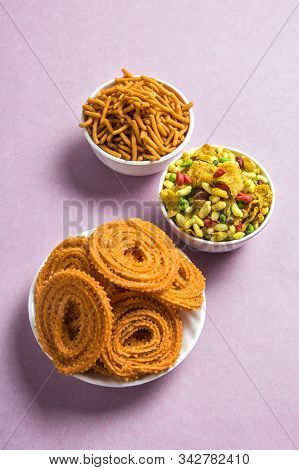 Indian Snack : Chakli, Chakali Or Murukku And Besan (gram Flour) Sev And Chivada Or Chiwada On Pink