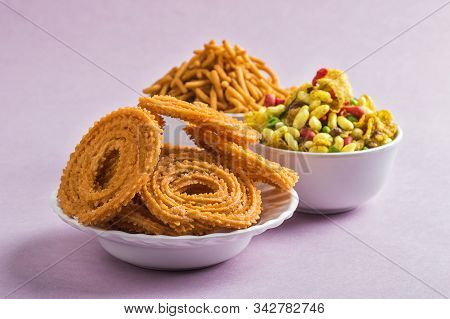 Indian Snack : Chakli, Chakali Or Murukku And Besan (gram Flour) Sev And Chivada Or Chiwada On Pink