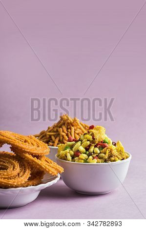 Indian Snack : Chakli, Chakali Or Murukku And Besan (gram Flour) Sev And Chivada Or Chiwada On Pink