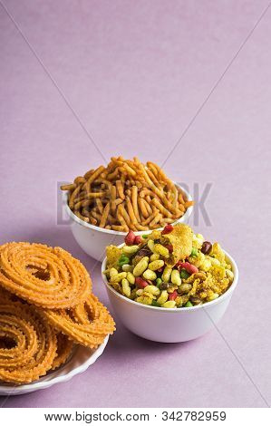 Indian Snack : Chakli, Chakali Or Murukku And Besan (gram Flour) Sev And Chivada Or Chiwada On Pink
