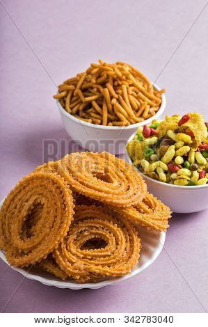Indian Snack : Chakli, Chakali Or Murukku And Besan (gram Flour) Sev And Chivada Or Chiwada On Pink