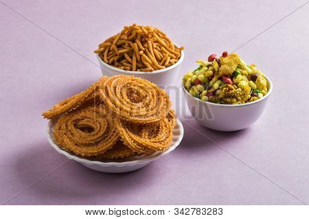 Indian Snack : Chakli, Chakali Or Murukku And Besan (gram Flour) Sev And Chivada Or Chiwada On Pink