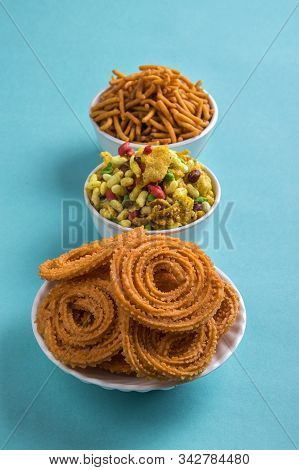 Indian Snack : Chakli, Chakali Or Murukku And Besan (gram Flour) Sev And Chivada Or Chiwada On Blue
