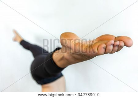 A Soft Focus Shot On The Dirty And Calloused Feet Of Woman In A Wide Legged Headstand During Yoga, I