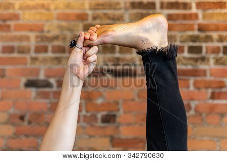 A Close Up Shot On The Bare Foot Of A Lady In A Yoga Posture, Holding Her Raised Toes With Hand Duri