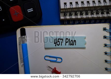 457 Plan Write On Sticky Note Isolated On Office Desk.