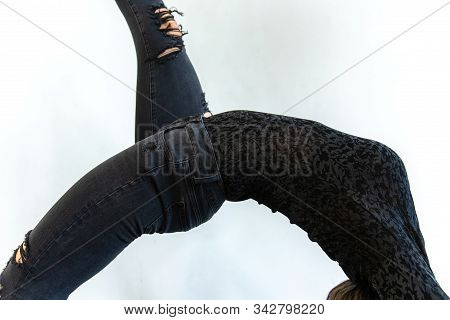 A Close Up And Side Shot On The Curved Spine And Body Of A Woman Wearing Black Floral Printed Top An