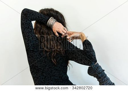 A Mindful And Empowered Woman Is Seen Wearing Black Gym Clothes As She Stretches Arms And Leg Behind