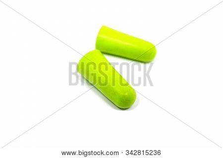 Green Ear Plugs Close-up On A White Background. Noise Reduction, Hearing Protection.