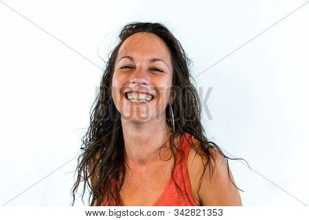A Closeup Portrait Of A Happy Woman With A Wide Toothy Smile And Sweaty Skin, Satisfied With Results